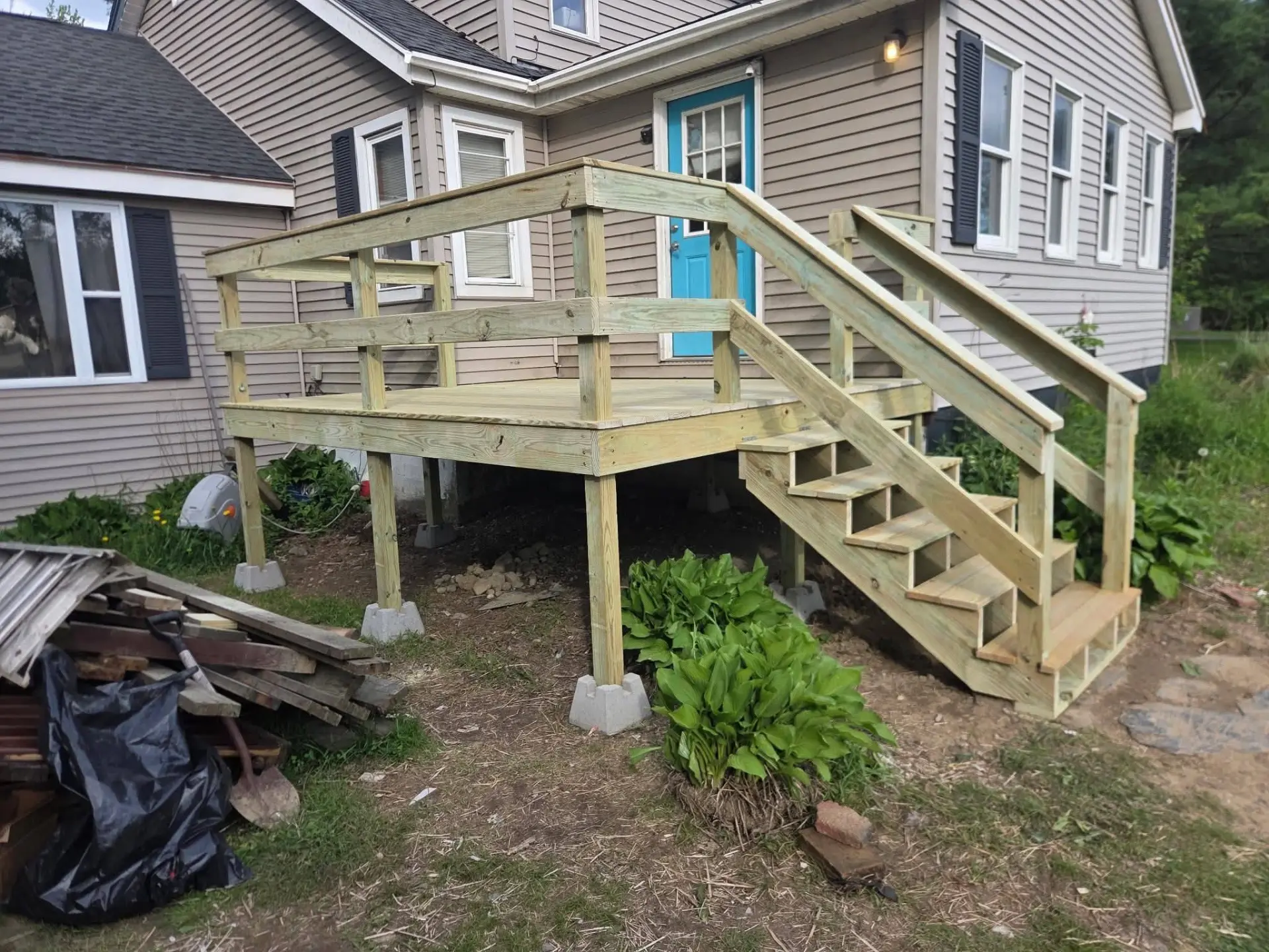 Timber entry platform, stairs, and railings at a residential property.